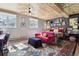 Eclectic bedroom with multiple windows, red sofa, and vintage-style rug at 916 Griffith St, Georgetown, CO 80444