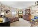 Traditional bedroom featuring floral wallpaper, a quilt-covered bed, and wood furniture at 916 Griffith St, Georgetown, CO 80444