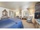 Charming bedroom featuring paneled walls, a brick fireplace, and classic furniture with a blue bedspread at 916 Griffith St, Georgetown, CO 80444