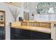 Stylish desk area with wooden countertops, black cabinets, and a large window at 916 Griffith St, Georgetown, CO 80444