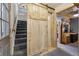 Hallway with wooden door leading to second floor staircase and living room at 916 Griffith St, Georgetown, CO 80444
