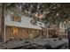 Charming home featuring a large wooden deck, gravel landscaping, and dormer windows under a dusk sky at 916 Griffith St, Georgetown, CO 80444