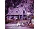 Charming vintage two-story home featuring a wood fence and a quaint balcony, nestled against a mountain backdrop at 916 Griffith St, Georgetown, CO 80444