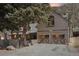 Charming home featuring wood siding, a two-car garage and mature landscaping at 916 Griffith St, Georgetown, CO 80444