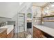 Kitchen featuring a farmhouse sink, wood cabinets, and stainless steel dishwasher at 916 Griffith St, Georgetown, CO 80444