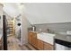 Kitchen featuring a farmhouse sink, wood cabinets, and stainless steel dishwasher at 916 Griffith St, Georgetown, CO 80444