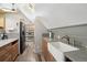 Kitchen featuring a farmhouse sink, wood cabinets, stainless steel refrigerator, and walk-in pantry at 916 Griffith St, Georgetown, CO 80444