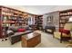 Comfortable living room featuring a brick fireplace and an abundance of bookshelves at 916 Griffith St, Georgetown, CO 80444