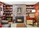 Charming living room featuring a brick fireplace and built-in shelving at 916 Griffith St, Georgetown, CO 80444
