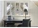 Bright office space with a classic black desk, large window, and paneled walls, creating a comfortable work area at 916 Griffith St, Georgetown, CO 80444