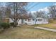 Spacious backyard with a patio area, green grass, and a charming white fence at 3075 S Emerson Way, Englewood, CO 80113