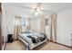 Serene bedroom with a queen-sized bed, soft curtains, and a ceiling fan for a cozy and comfortable retreat at 3075 S Emerson Way, Englewood, CO 80113