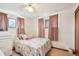 Calm bedroom with a full-sized bed, soft pink accents, and natural light from the windows for a restful ambiance at 3075 S Emerson Way, Englewood, CO 80113