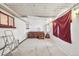 Unfinished space featuring a hot tub, drop ceiling, and a window with a red curtain at 3075 S Emerson Way, Englewood, CO 80113