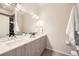 Bright bathroom featuring double sinks, modern fixtures, and a large mirror at 3256 Federal Blvd, Denver, CO 80211