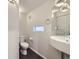 Modern half-bathroom with stylish sink, lighting, and sleek fixtures at 3256 Federal Blvd, Denver, CO 80211