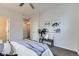 Relaxing bedroom with a bench, wall art, and plush throw blanket on the bed at 3256 Federal Blvd, Denver, CO 80211