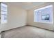Empty bedroom with lots of natural light, carpet, and a neutral color scheme at 3256 Federal Blvd, Denver, CO 80211