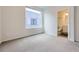 Cozy bedroom with plush carpet and attached bathroom for added privacy at 3256 Federal Blvd, Denver, CO 80211