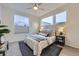 Bright bedroom with many windows, a ceiling fan, and a beautifully made bed at 3256 Federal Blvd, Denver, CO 80211