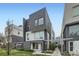 Modern exterior showcasing clean lines and a mix of dark brick and siding, enhanced by a manicured lawn at 3256 Federal Blvd, Denver, CO 80211