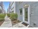 Inviting front entrance with a modern glass door, manicured shrubs, and visible unit number for easy access at 3256 Federal Blvd, Denver, CO 80211