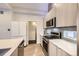Well-appointed kitchen with stainless steel appliances, gas range, and modern cabinetry at 3256 Federal Blvd, Denver, CO 80211