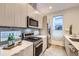 Well-equipped kitchen featuring stainless steel appliances, modern cabinetry, and a gas range for cooking enthusiasts at 3256 Federal Blvd, Denver, CO 80211