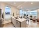 Bright, open kitchen flowing into the living space with modern appliances and countertops at 3256 Federal Blvd, Denver, CO 80211
