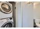 Stackable washer and dryer in the laundry room adjacent to white folding doors at 3256 Federal Blvd, Denver, CO 80211