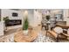 Modern living room with sleek fireplace, wood floors, and view to the kitchen and dining area at 3256 Federal Blvd, Denver, CO 80211