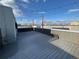 Expansive rooftop deck featuring stylish gray decking, string lights, and ample space for outdoor entertaining at 3256 Federal Blvd, Denver, CO 80211