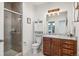 Bathroom with a glass-enclosed shower, modern vanity, granite countertop, and designer mirror and lighting at 2936 Merry Rest Way, Castle Rock, CO 80109