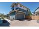 Exterior view of a two-story home with a gray garage door and brick driveway, showcasing modern architecture at 2936 Merry Rest Way, Castle Rock, CO 80109