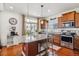 Open concept kitchen with stainless appliances, granite countertops, and a red center island at 2936 Merry Rest Way, Castle Rock, CO 80109