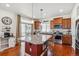 Open concept kitchen with stainless appliances, granite countertops, and a red center island at 2936 Merry Rest Way, Castle Rock, CO 80109