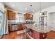 Bright kitchen features stainless steel appliances, granite counters, hardwood floors and modern lighting at 2936 Merry Rest Way, Castle Rock, CO 80109