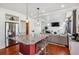 Open concept kitchen with stainless appliances, granite countertops, and a red center island at 2936 Merry Rest Way, Castle Rock, CO 80109