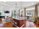 Open concept kitchen with stainless appliances, granite countertops, and seating at the red island at 2936 Merry Rest Way, Castle Rock, CO 80109