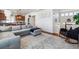 Open-concept living area with a comfortable sectional, seamlessly connecting to the kitchen and dining spaces at 2936 Merry Rest Way, Castle Rock, CO 80109