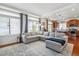 Spacious living area with large windows, a comfortable sectional sofa, and an open layout to the kitchen at 2936 Merry Rest Way, Castle Rock, CO 80109