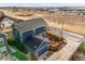 Aerial view of the home showcasing a back deck, fenced yard, and solar panels at 7903 E 50Th Dr, Denver, CO 80238