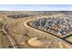 Aerial view of a planned community showcasing modern homes, streets, and landscaping in a suburban setting at 7903 E 50Th Dr, Denver, CO 80238