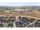 Aerial view showcasing the neighborhood, nearby shopping centers, and distant mountain views at 7903 E 50Th Dr, Denver, CO 80238