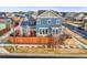 Aerial view of the property highlighting a backyard deck, solar panels, and neighborhood at 7903 E 50Th Dr, Denver, CO 80238