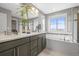 Sleek bathroom featuring double sinks, a soaking tub, and ample counter space, perfect for relaxation and pampering at 7903 E 50Th Dr, Denver, CO 80238