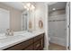 Bathroom featuring a double vanity with a mirror and a shower and tub combo at 7903 E 50Th Dr, Denver, CO 80238