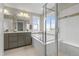Bright bathroom featuring a soaking tub, shower, and gray vanity with double sinks at 7903 E 50Th Dr, Denver, CO 80238