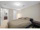 Serene bedroom features soft lighting, a comfortable bed, and adjacent bathroom, creating a cozy private space at 7903 E 50Th Dr, Denver, CO 80238