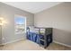 Cozy bedroom with a carpeted floor, a window with a view and a bunk bed at 7903 E 50Th Dr, Denver, CO 80238